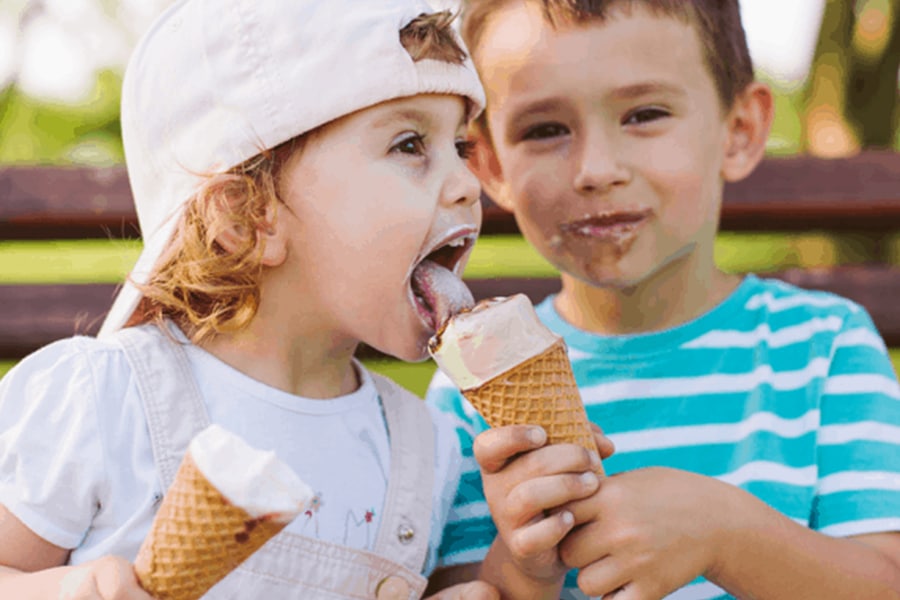 A happy family receiving soft serve cones at a Perth event